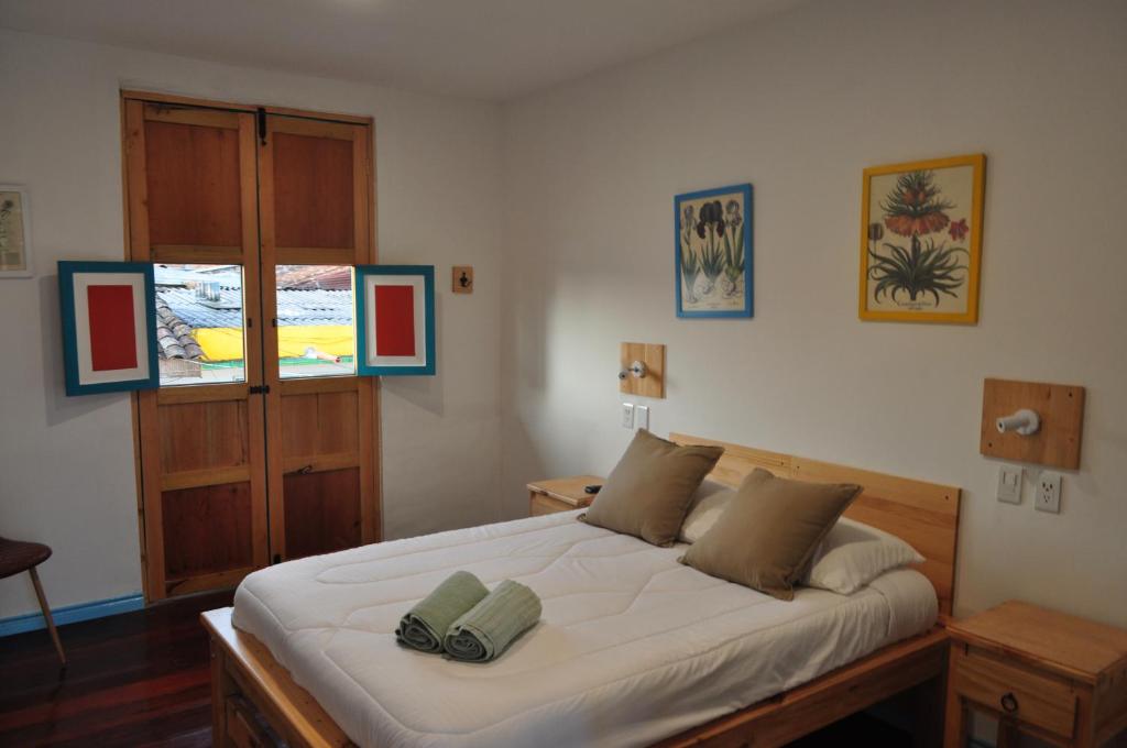 a bedroom with a large bed with two pillows on it at Bidea Backpackers Hostel in Filandia