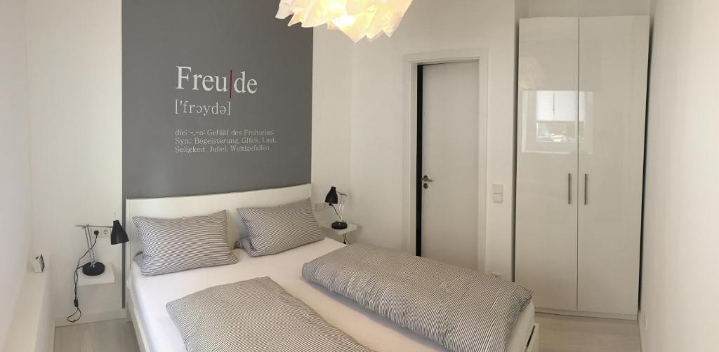 a bedroom with a bed and a chandelier at Apart-ment 84 in Herdecke