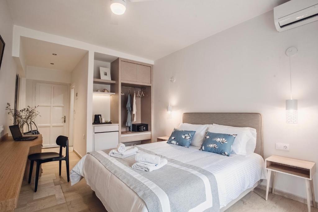 A bed or beds in a room at Iliada Beach Hotel
