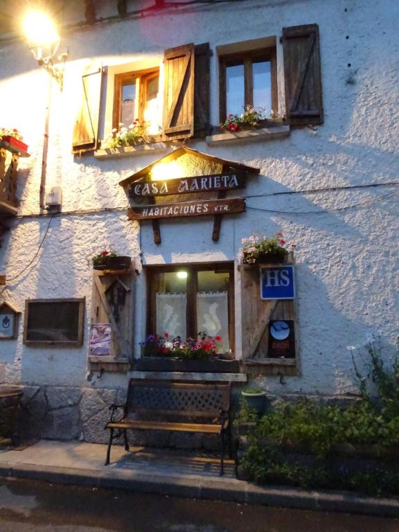 a building with a bench in front of it at Casa Marieta in Canfranc-Estación