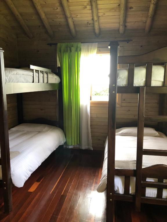 Cama o camas de una habitación en Cabañas Filadelfia