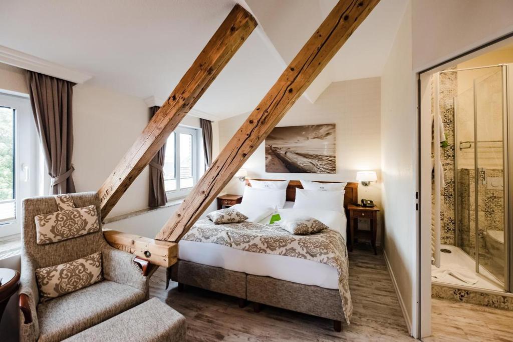 A bed or beds in a room at HOTEL DÜNENLÄUFER Langeoog