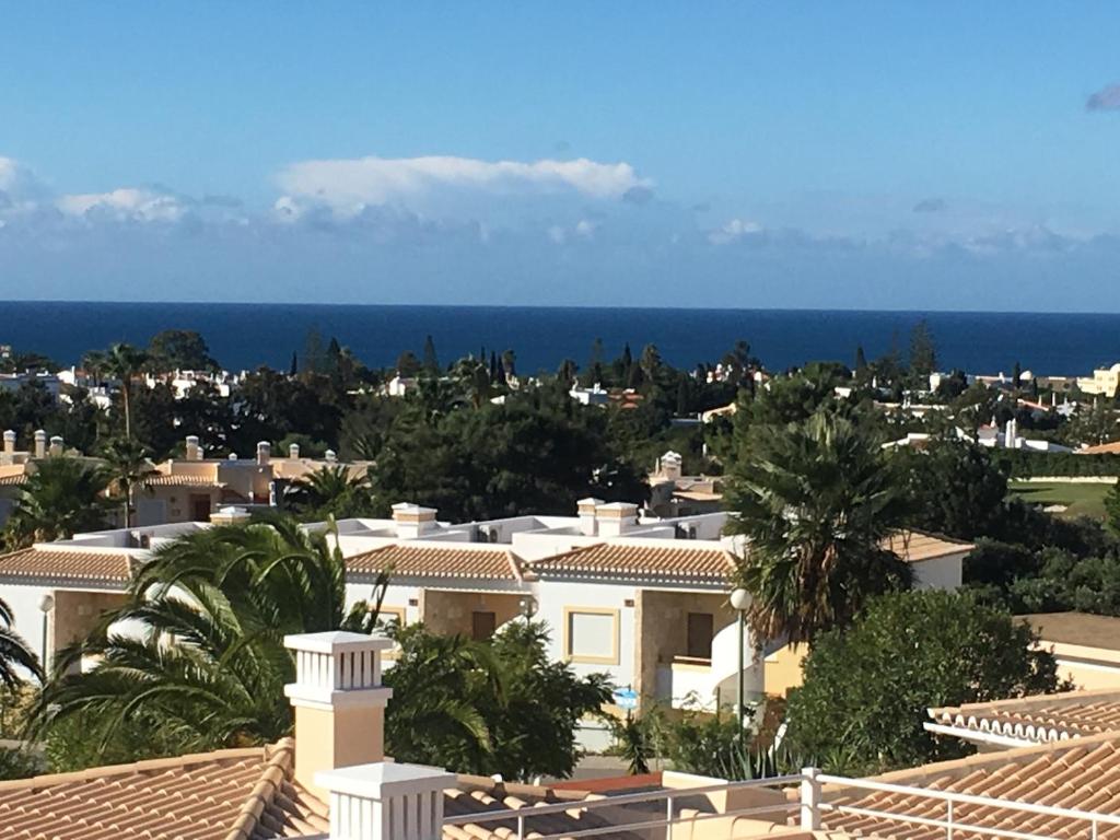 a view of a city with houses and the ocean at Casa Atlantida Golfemar in Carvoeiro