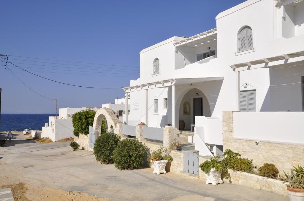 a white building with the ocean in the background at Vavanos Studios in Naousa