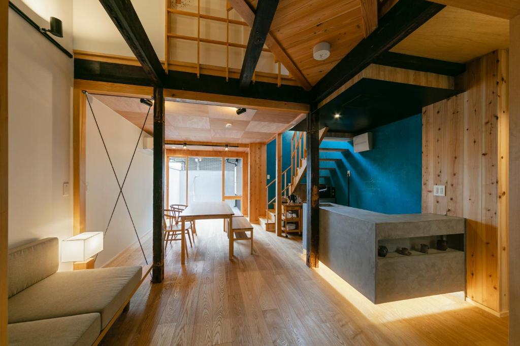 a living room with a couch and a table at Machiya Hotel YANAGI in Kyoto