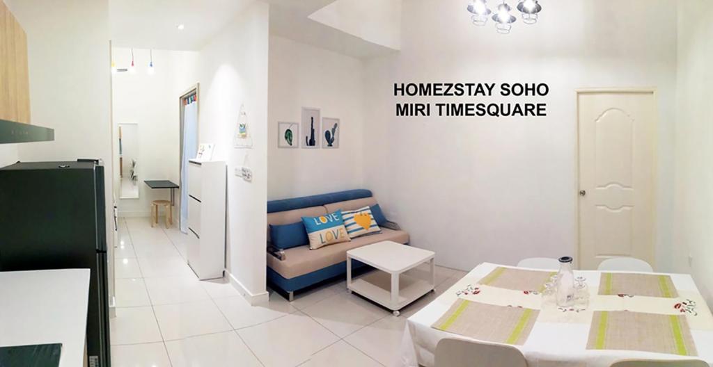 a living room with a couch and a table at HomezStay Soho Timesquare Miri in Miri