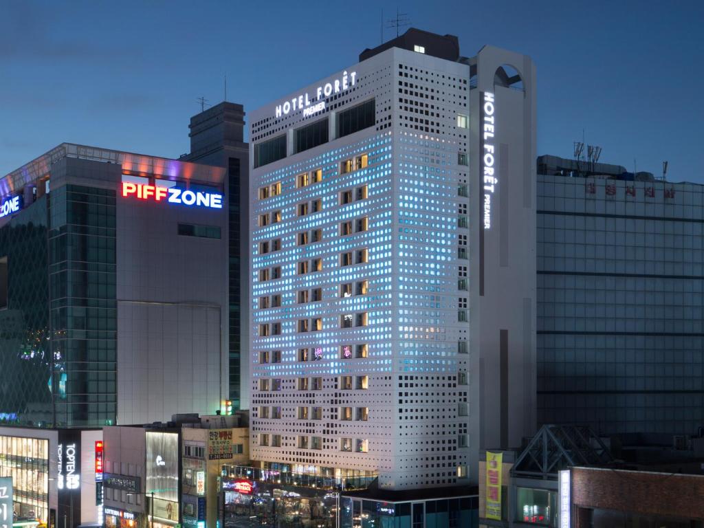 a tall building with a sign on the side of it at Hotel Foret Premier Nampo in Busan