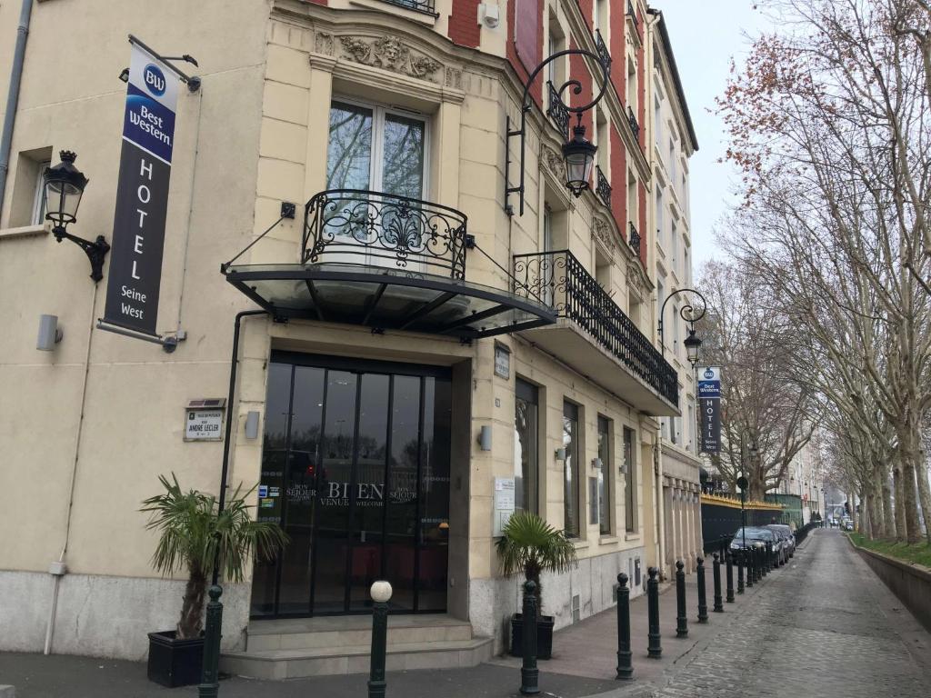 um edifício com uma varanda ao lado de uma rua em Best Western Seine West Hotel em Puteaux