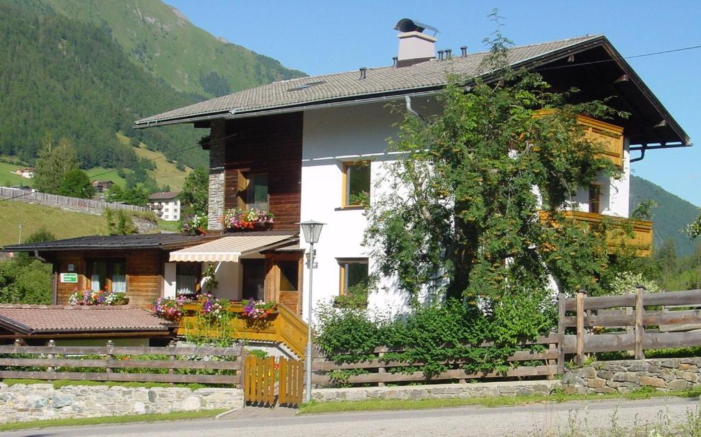 a house with a fence in front of it at Apartments Auenheim in Prägraten