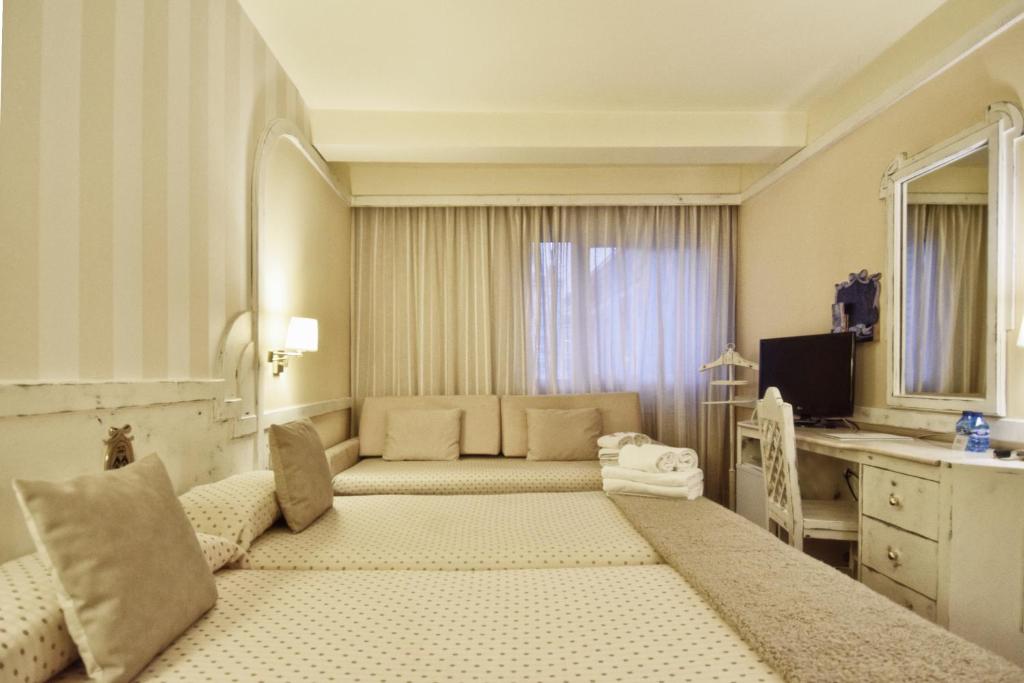 Postel nebo postele na pokoji v ubytování Hotel Maria Luisa