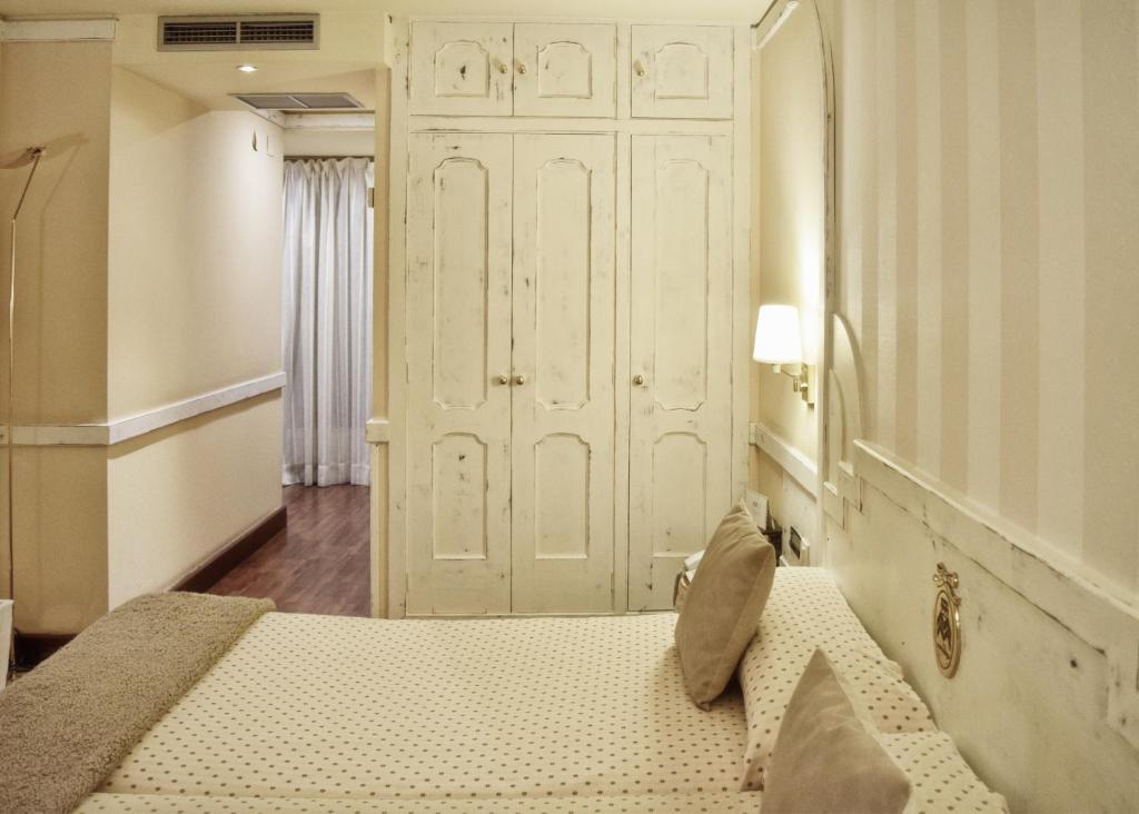 Postel nebo postele na pokoji v ubytování Hotel Maria Luisa
