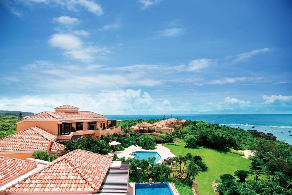 an aerial view of a house and the ocean at The Shigira in Miyako Island
