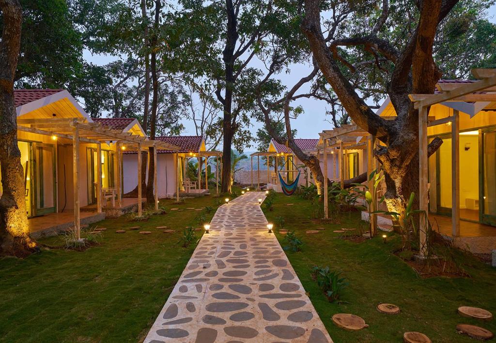 a cobblestone path in front of a row of houses at Blu Resorts in Vagator