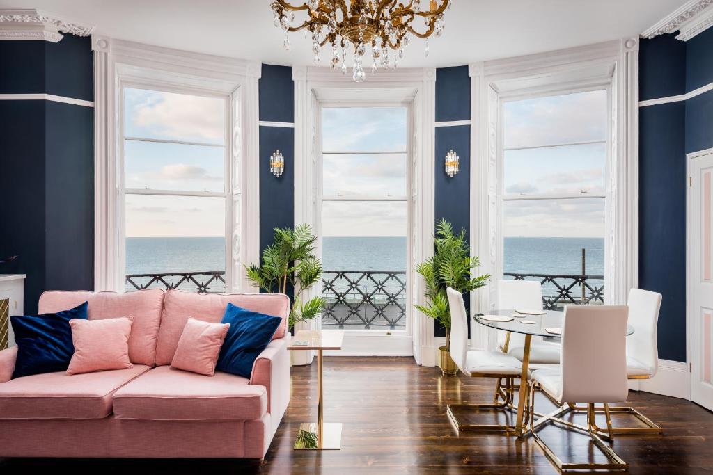 a living room with a pink couch and a table at The Hollywood Apartment in Brighton & Hove