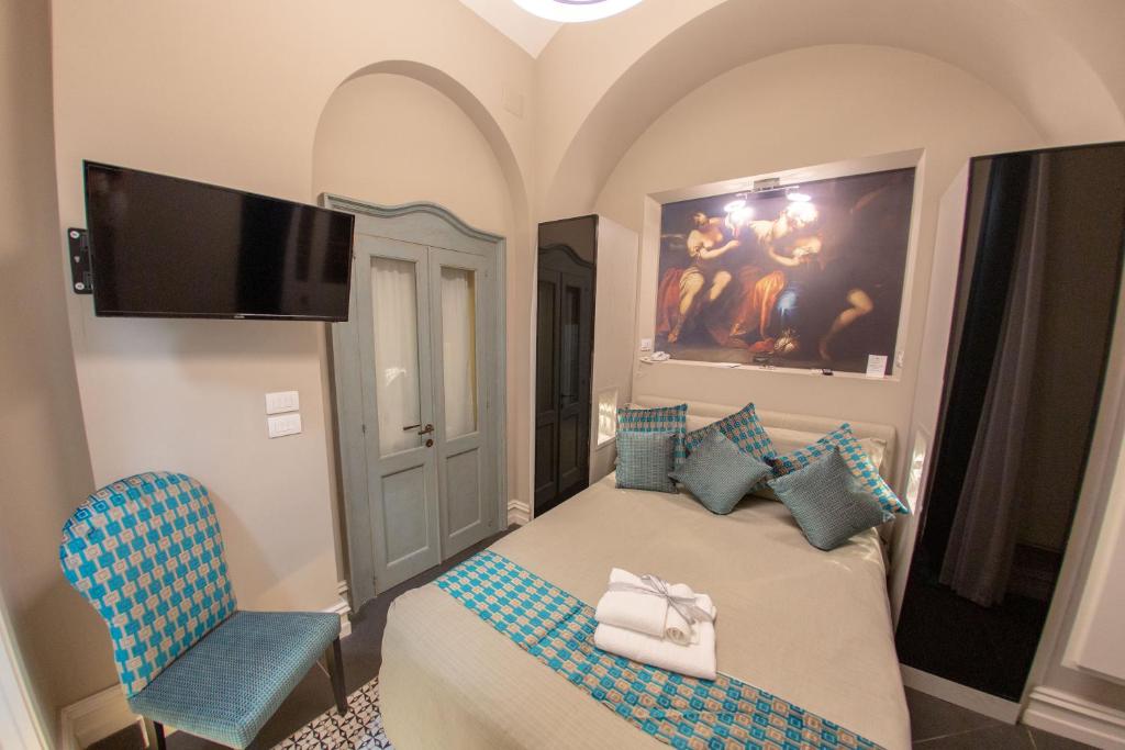 Letto o letti in una camera di Leone Camere D'autore - CHIAIA
