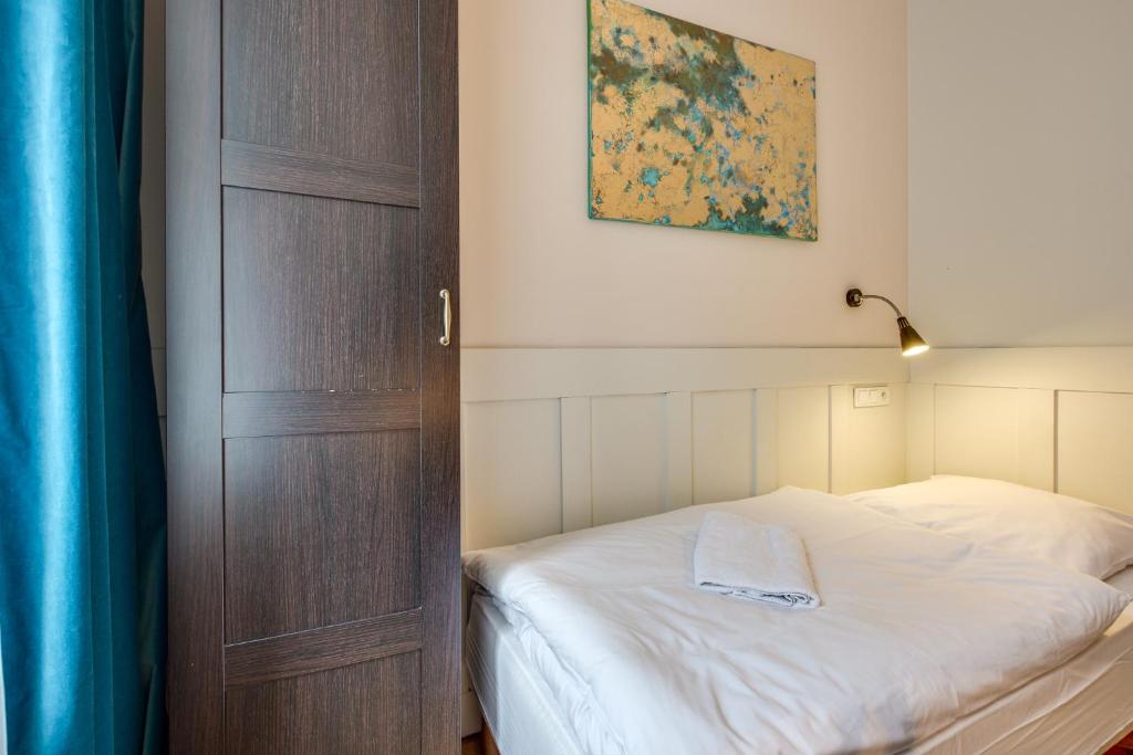 Postel nebo postele na pokoji v ubytování Mickiewicza Suites