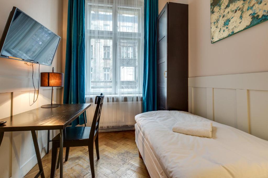 Postel nebo postele na pokoji v ubytování Mickiewicza Suites