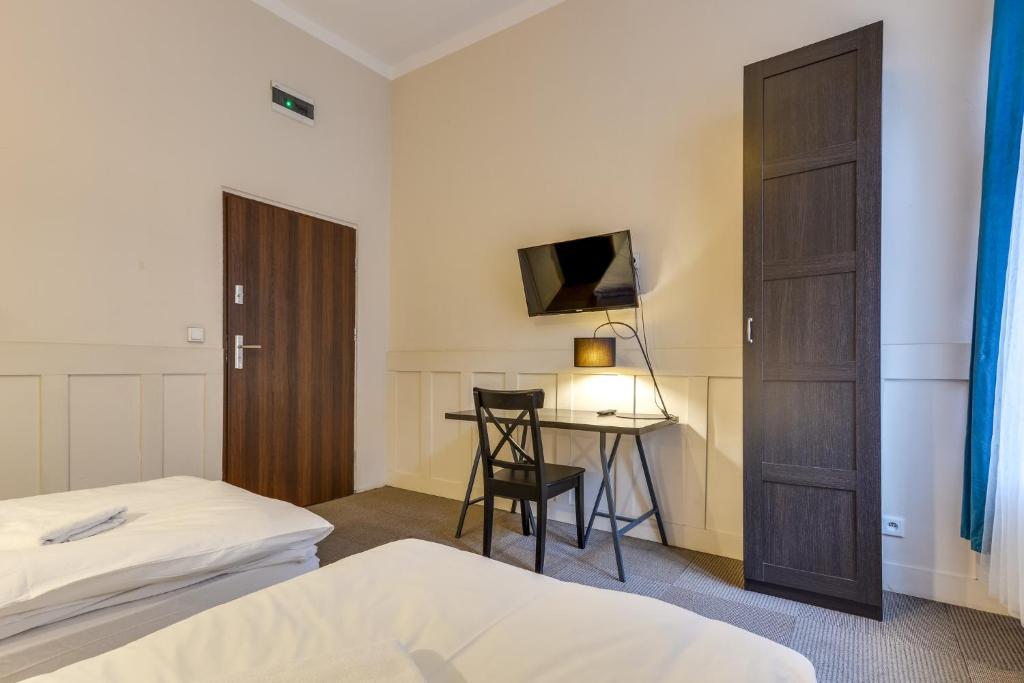 Postel nebo postele na pokoji v ubytování Mickiewicza Suites