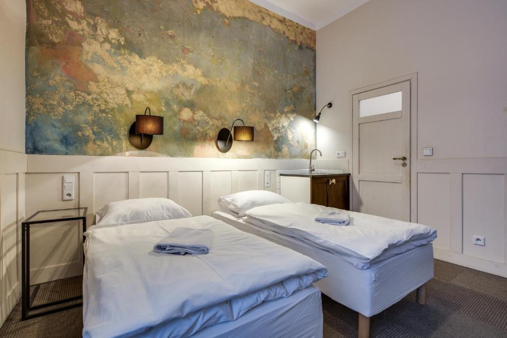 Postel nebo postele na pokoji v ubytování Mickiewicza Suites
