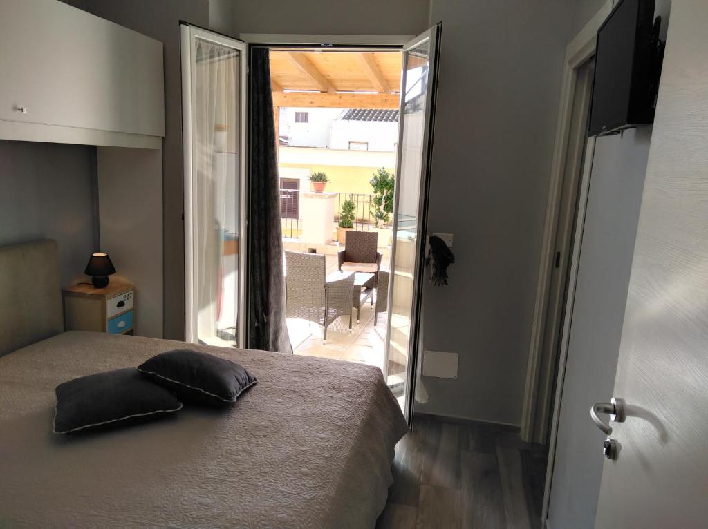 a bedroom with a bed and a view of a patio at B&B Nazareth in Barletta