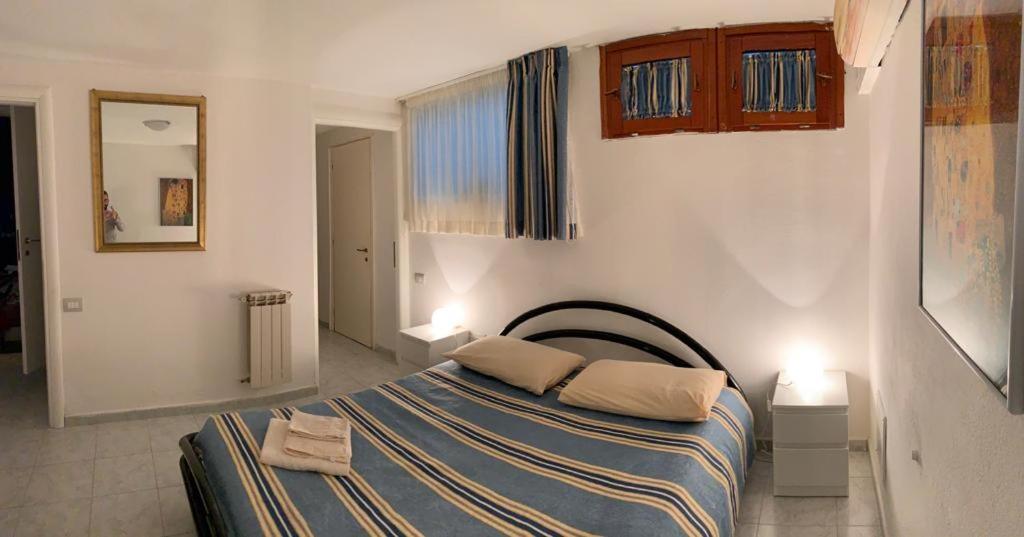 a bedroom with a bed with two towels on it at Viniola Apartment in Quartu SantʼElena