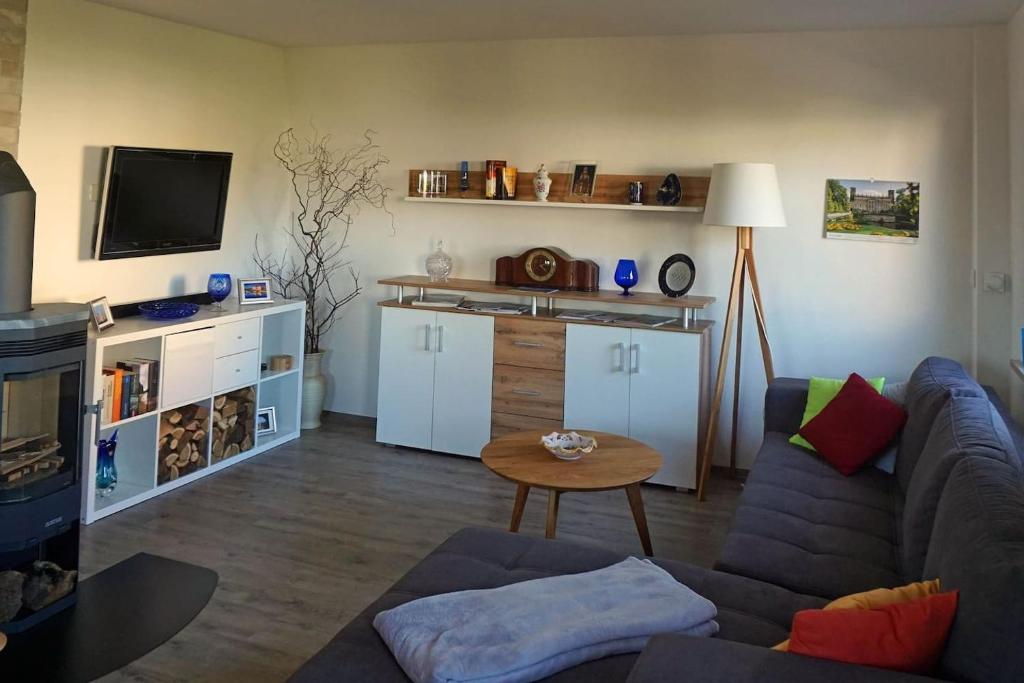 a living room with a couch and a table at FeWo „Zum Napoleonstein“ in Dresden