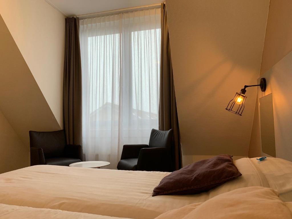 Postel nebo postele na pokoji v ubytování Hotel In den Brouwery