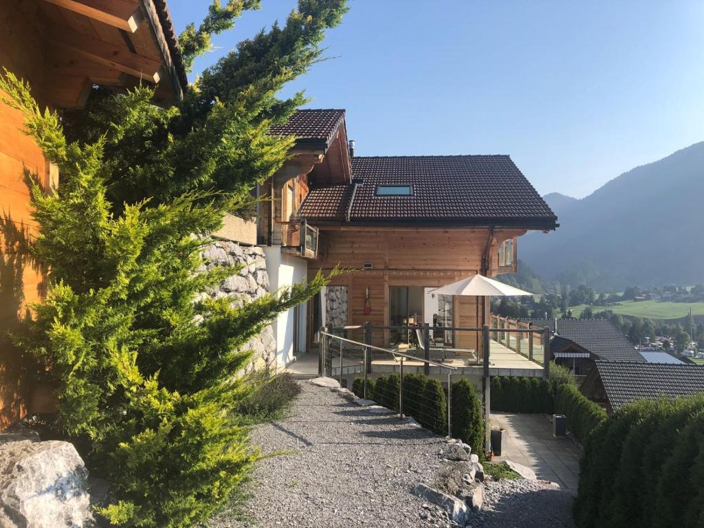 a house in the mountains with a pathway leading to it at Eggetli in Zweisimmen