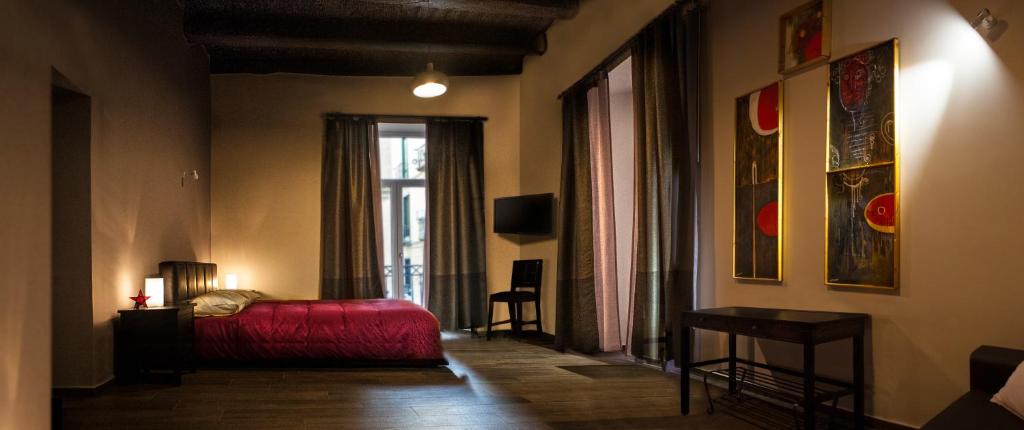 a bedroom with a red bed and a window at B&B PETER PAN in Salerno