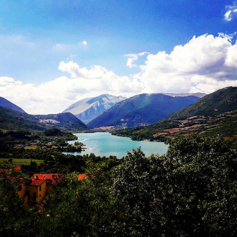 a view of a lake in a valley with mountains at Lago Vivo in Barrea