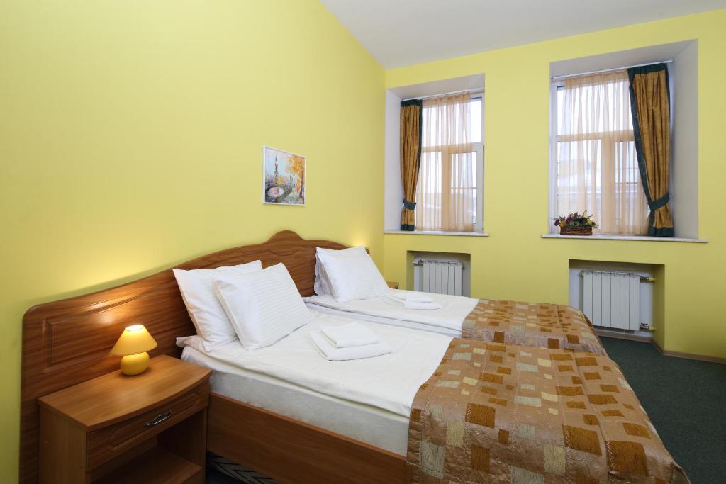 
Кровать или кровати в номере Гостевые Комнаты "Невский 150"
