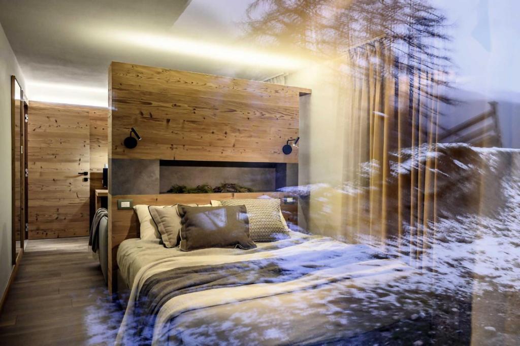 um quarto com uma cama e uma parede de madeira em B&B Al Castel em Padola