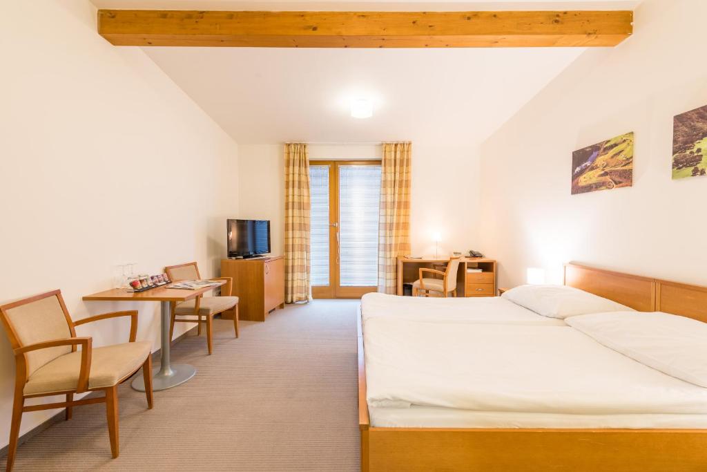Ein Bett oder Betten in einem Zimmer der Unterkunft Hotel Kaskáda