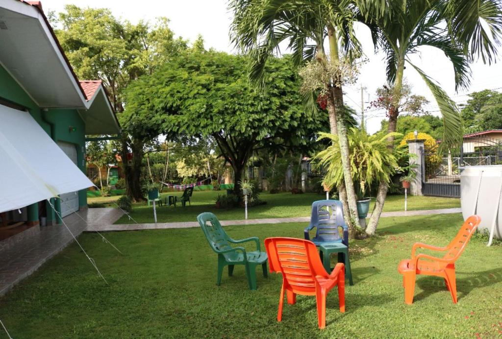 a group of chairs sitting in the grass at Bed and Breakfast Little Italy in Boquerón