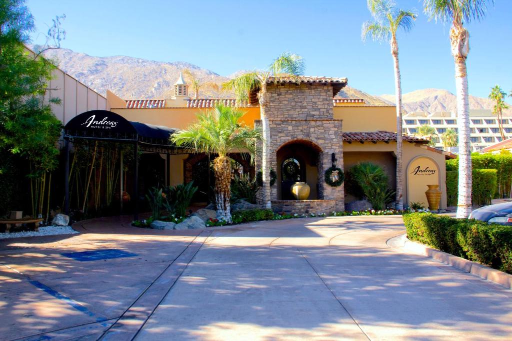 a house with palm trees in front of a driveway at Andreas Hotel & Spa in Palm Springs