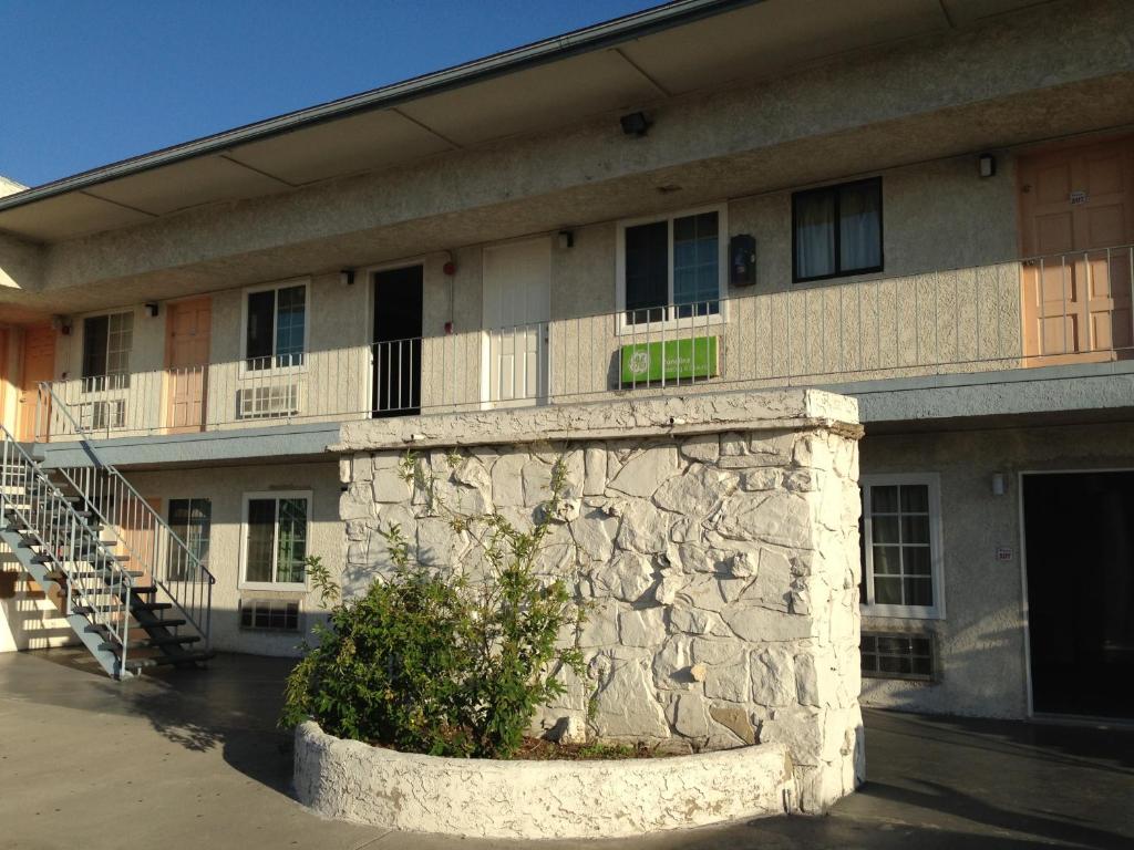 a building with a stone wall and a building with windows at Economy Inn in Sun Valley