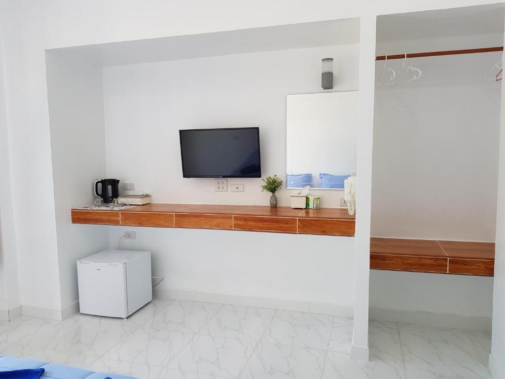a living room with a tv on a counter at Mook Ing Lay in Ko Mook