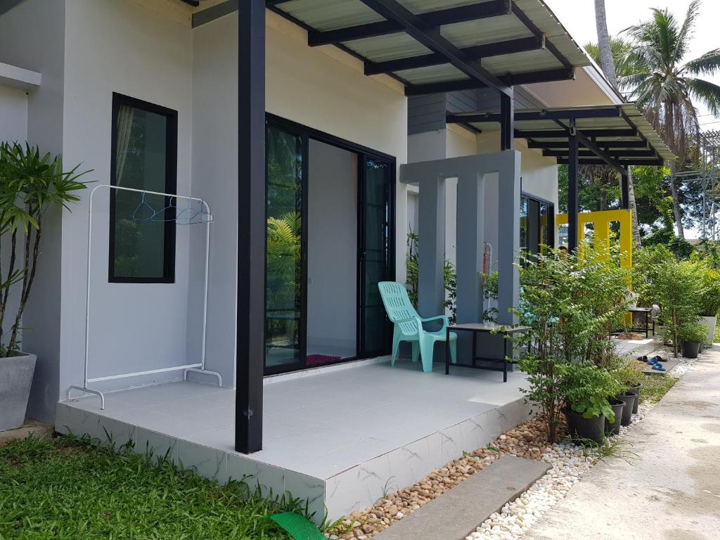 a house with a blue chair on the porch at Mook Ing Lay in Ko Mook