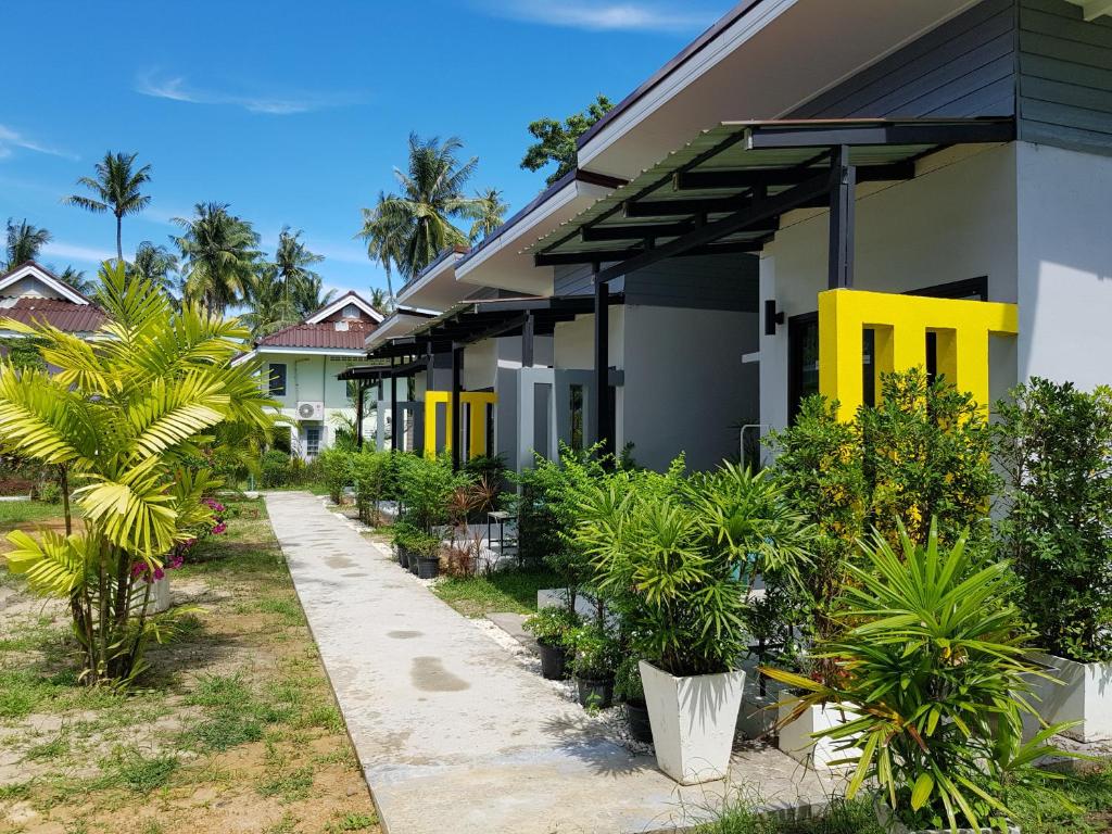 a house with yellow doors and plants in front of it at Mook Ing Lay in Ko Mook