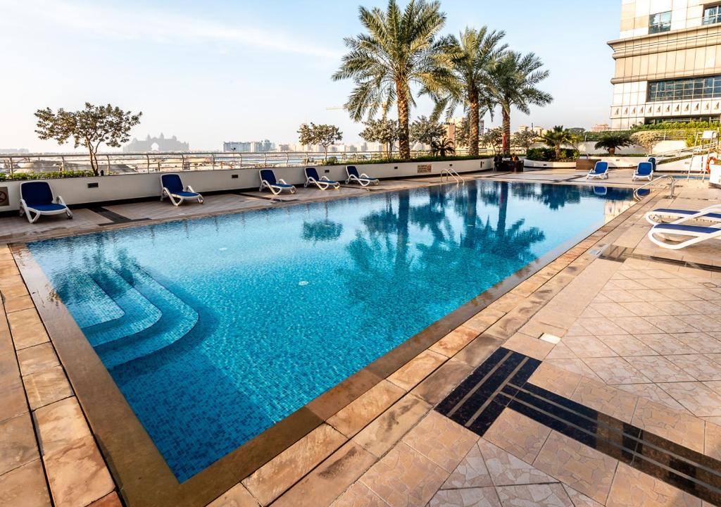 a swimming pool on the roof of a building at Peaks Apartments Dubai Marina in Dubai