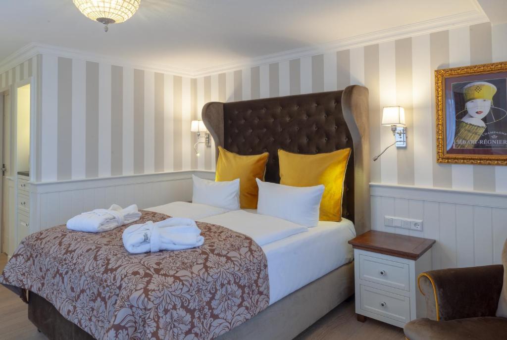 a bedroom with a bed with towels on it at Europa Hotel Kühlungsborn in Kühlungsborn