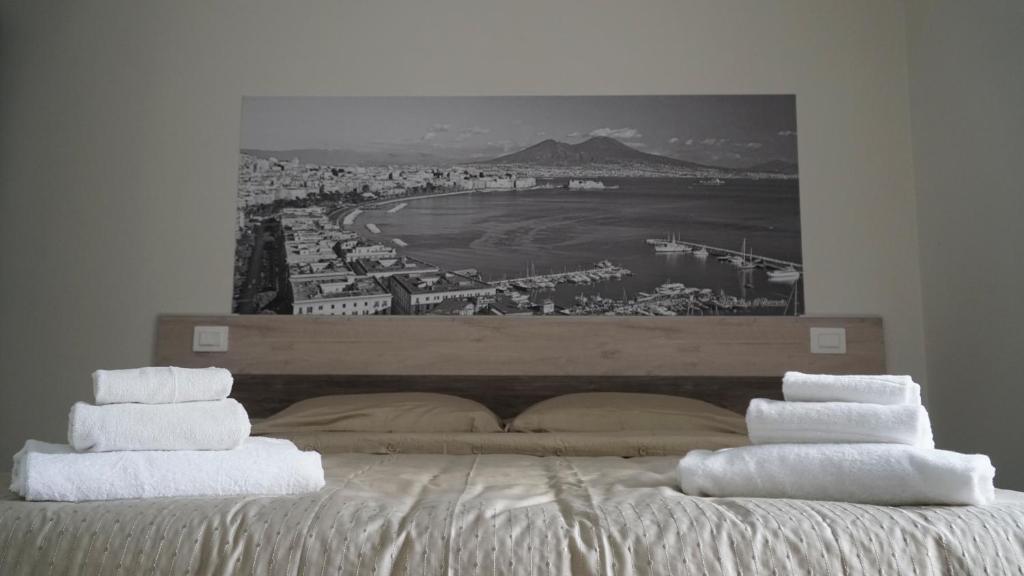 a bedroom with a bed with towels on it at Donna Vicenza Bed & Breakfast in Naples