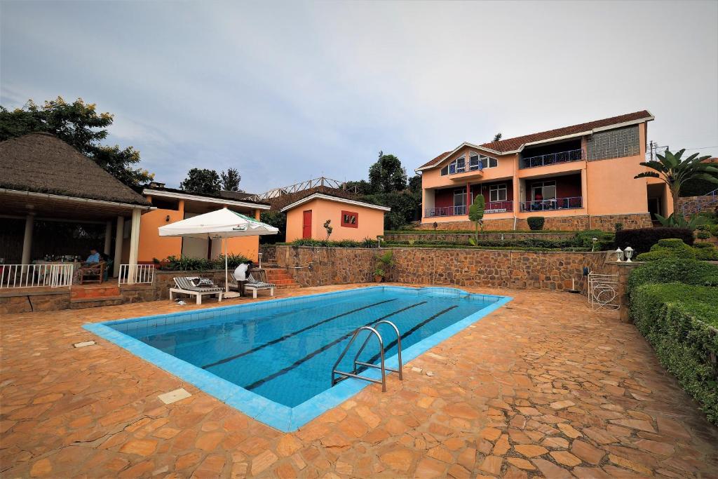 a swimming pool in front of a house at Villa Belle Vue in Kigali