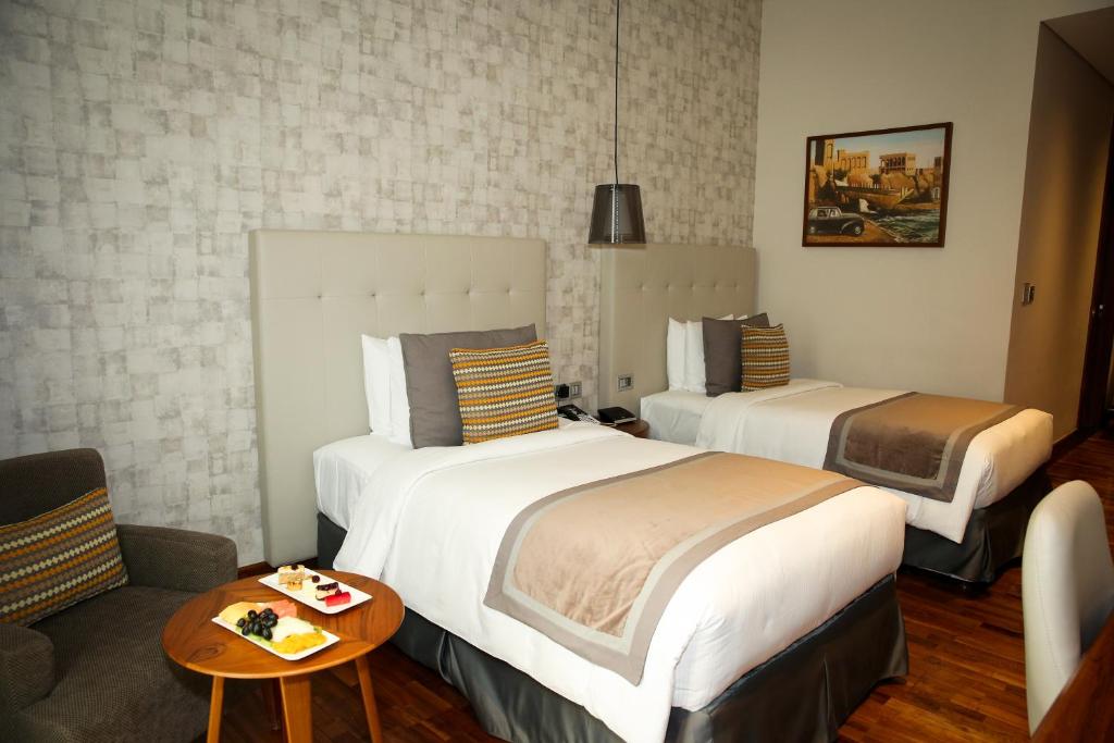 Postel nebo postele na pokoji v ubytování The Avenue Hotel
