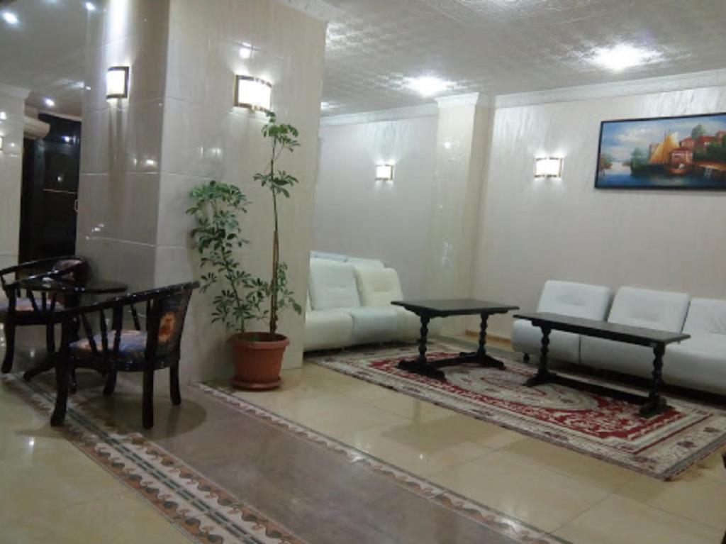 a living room with a couch and a table at Hotel De L'aeroport in Alger