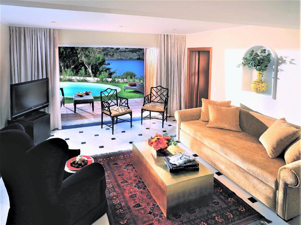 a living room with a couch and a table at Out Of The Blue Resort & Spa in Agia Pelagia