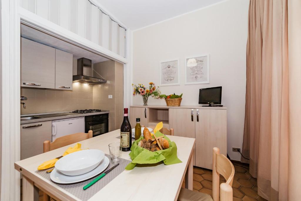 a kitchen with a table with a bottle of wine at Residence Emanuel in Diano Marina