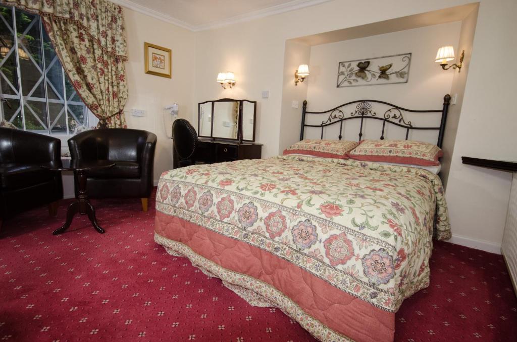 Postel nebo postele na pokoji v ubytování Stow Lodge Hotel