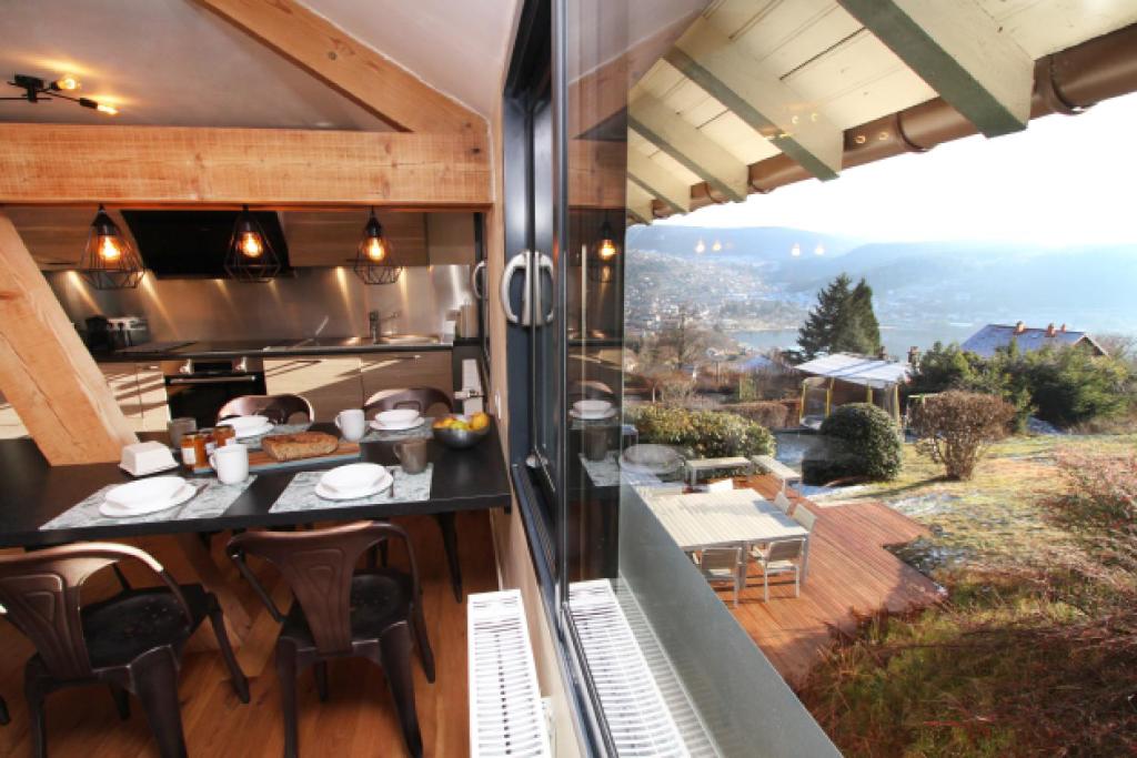 an outdoor kitchen with a view of a garden at Le Grenier du 11 in Gérardmer