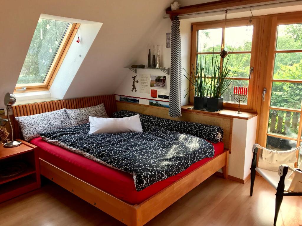 a bedroom with a bed and two windows at Ferienwohnung Wremer Straße in Wremen